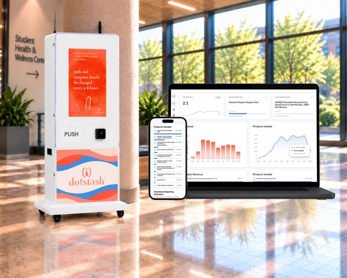 A white Dotstash Smart Health and Wellness Vending Machine for school campuses in a modern lobby next to a laptop and smartphone displaying its digital dashboard interface for the Dotstash Impact Portal